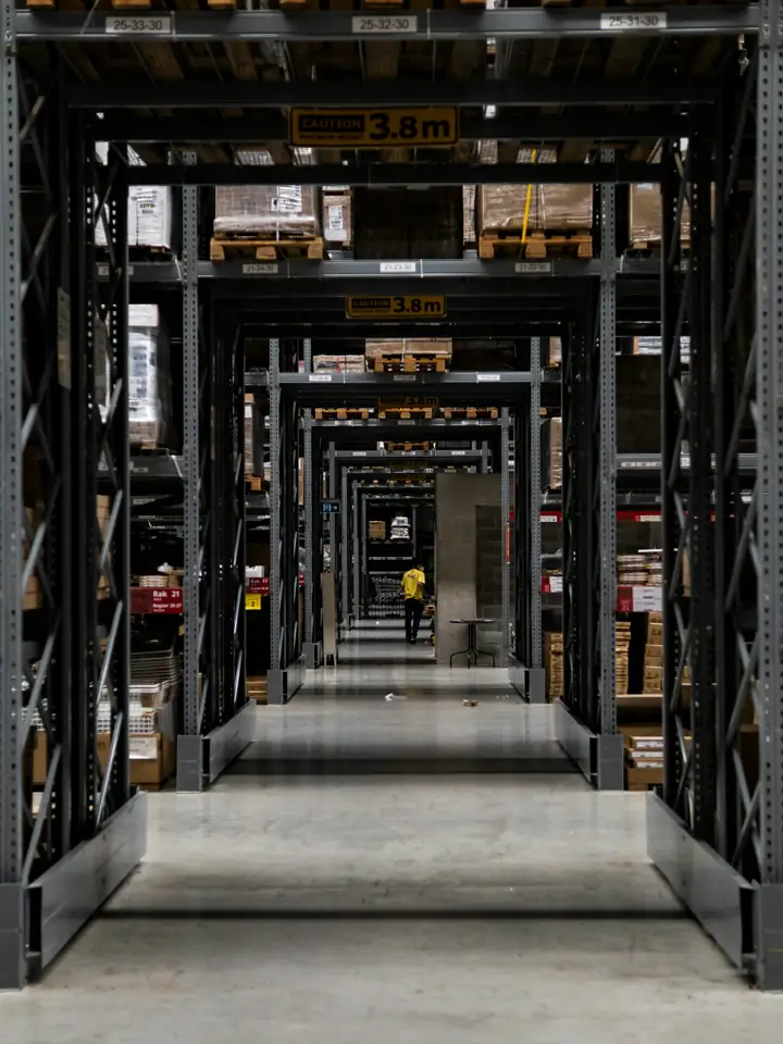 A long warehouse aisle lined with tall shelves